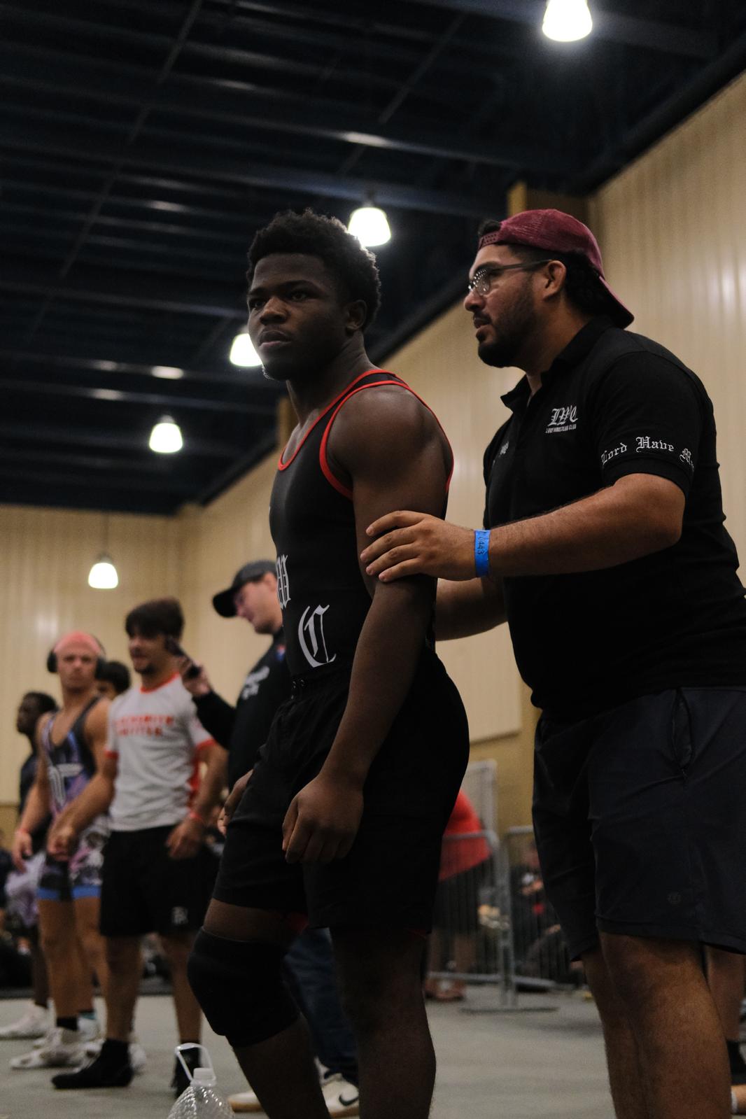 Coach Ray Lugo with an athlete at a tournament